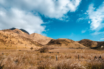 Fototapeta na wymiar landscape of the dried grass mountains with beautiful sky.