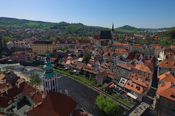 Fototapeta na wymiar Wide-angle aerial landscape view of old town of Cesky Krumlov (Krumau). Famous czech historical beautiful town. Vintage colorful buildings with red tile roof. UNESCO World Heritage Site