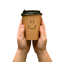 Paper coffee cup with a drawn smiling face in a hands on a transparent background