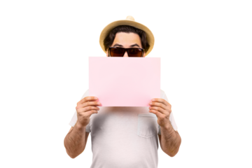 studio portrait of a guy in sunglasses and a panama hat isolated on transparent background, a man is holding a pink blank sheet for text, summer vacation concept