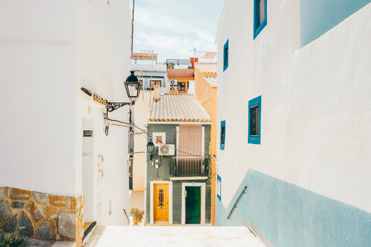 View to beautiful La Vila Joiosa street with multi-colored houses. Villajoyosa - coastal town in Alicante Province, Valencian Community, Spain, by Mediterranean Sea