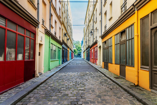 Vintage colorful workshops and art studios in a small cobblestone street in Paris, France