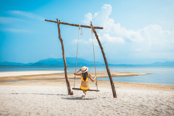 Traveler asian woman relax and travel in swing on summer beach at Koh Rap Samui in Surat Thani Thailand - 606374957