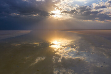 Evening landscape on the lake with the reflection of the sky in the water