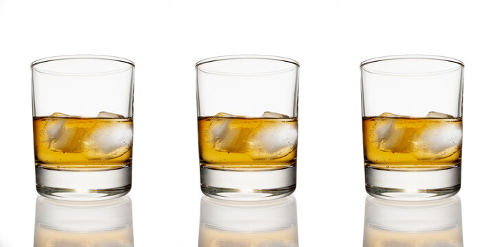 clean whiskey glass isolated on white background with a clipping path. Strong alcoholic cocktail with ice in a low glass isolated on white background