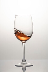 Splash of wine in a glass, motion blur, frozen wine motion