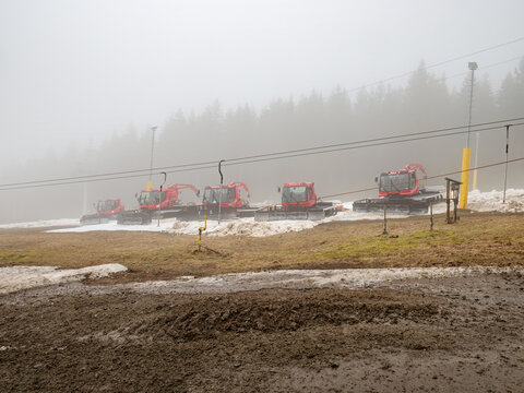 Red tractor, snow plough parked outside Ore mountain