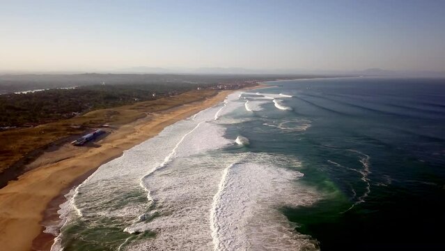 Aerial drone cinematic sunrise early morning wave swell stunning beachfront Hoosegor Capbreton Biarritz France Europe Bay of Biscay WSL Quiksilver Pro central Peronze sunny midday down movement