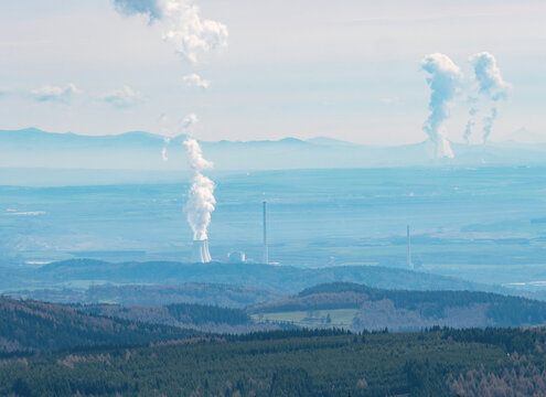 Smoking coal-fired power plant and steam cloud above. North East of Czechia