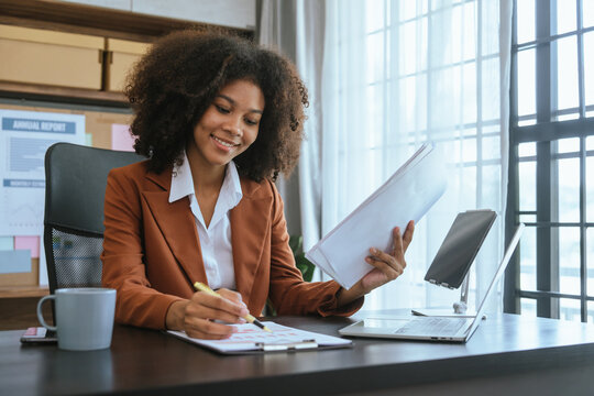 Working smart, African american business woman working audit balance sheet, job order costing, revenue recognition, break-even analysis, appropriated retained earnings, earned surplus, capital gain
