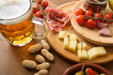 Select appetizer with beer mug on wooden table