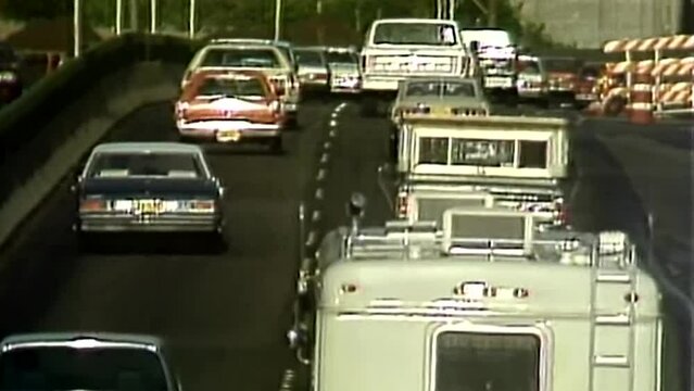 1980s Highway with cars and trucks driving away