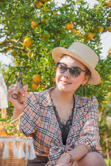 Cute thai girl happy traveling in orange farm in Chiang Mai, Thailand.