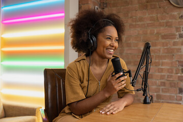 Influencer recording a podcast in a studio wearing headphones