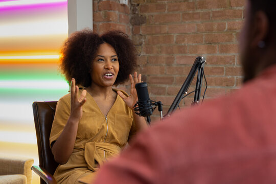 Black female interviewing guest for a podcast being live streamed
