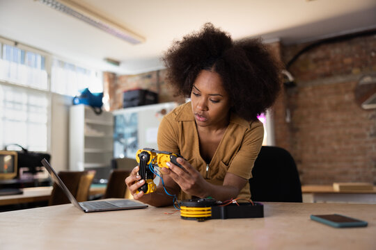African american woman working on robotic technology