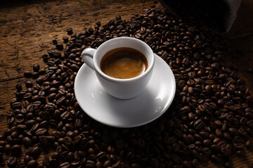 cup of coffee on top of coffee beans.