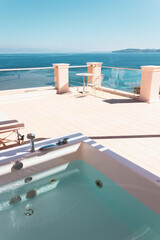 Terrace with sun loungers, outdoor hot tub and sea views. Relaxed holidays in a Mediterranean resort in Greece