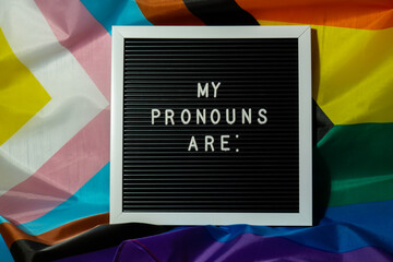 MY PRONOUNS ARE text Neo pronouns concept on Rainbow flag background gender pronouns. Non-binary...