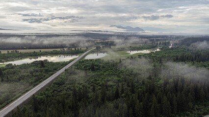 Fototapeta na wymiar Aerial shot of a river under a cloudy sky in Invermere, BC, Canada.