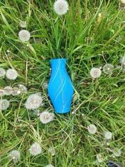 3D printed vase. Multicolored 3D printed vase among green grass