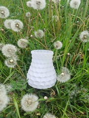 3D printed vase. Multicolored 3D printed vase among green grass