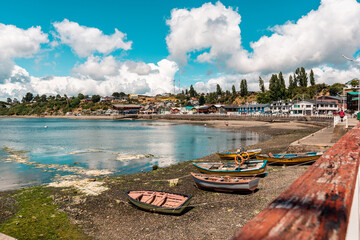 Scenic view of wooden boats and colorful houses on a shore of a lake in Chonchi, Chiloe, Chile