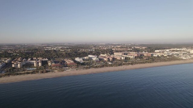 Establishing shot of scenic coastal town with sandy beach. Islantilla, Spain