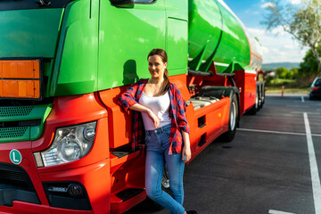 A young woman poses in front of her first cargo truck before embarking on a cross-country tour