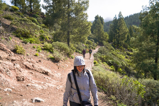 Hiking group ascending to Roque Nublo duroing a misty morning in
