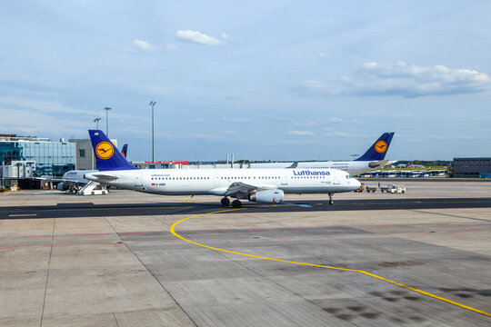 Lufthansa aircraft parking at the apron in Frankfurt, Germany.  There is Lufthansas primary traffic hub and the majority of Lufthansas flying staff is based there