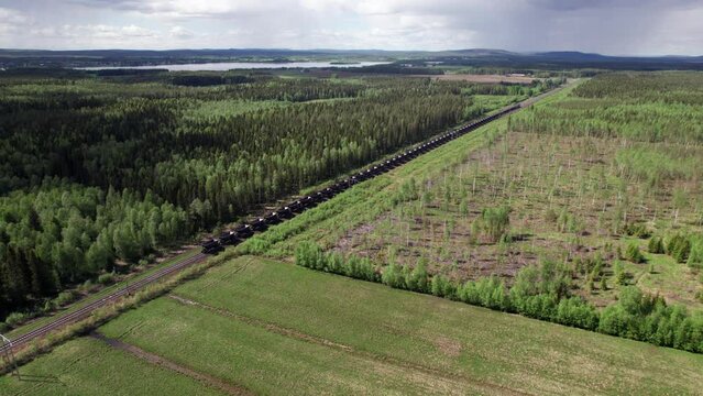 Drone View of Empty Swedish Freight Train, Cargo, Scandinavia, Kiruna, Lule&aring;, Forest Landscape, Pull out,