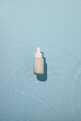 Bottle of sunscreen spray on a pastel background with space for text and design elements