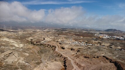 Fototapeta na wymiar Aerial view of clouds rolling over lowland of Tenerife, Canary Islands in Spain