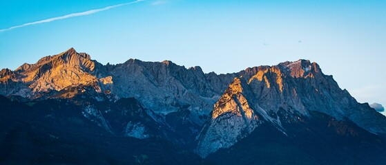 Fototapeta na wymiar Panoramic shot of mountain peaks during the sunrise