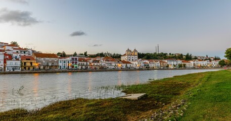 Fototapeta na wymiar Beautiful landscape over the riverside area of Alcacer do Sal, Portugal with buildings on the shore