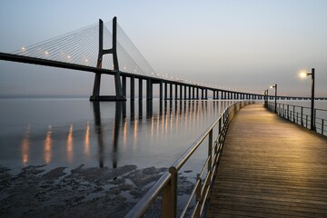 Fototapeta na wymiar Beautiful sunrise over the historic Vasco da Gama bridge in Lisbon, Portugal