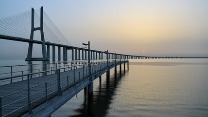 Fototapeta na wymiar Mesmerizing sunrise view over the Vasco of Gama Bridge on the Tagus River in Lisbon, Portugal
