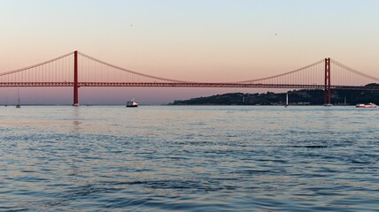 Fototapeta na wymiar View of 25 de Abril Bridge at sunset. Lisbon, Portugal.