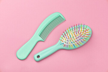 Hair comb and brush on a pink background