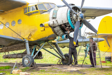 Repair and maintenance of propeller-driven aircraft. Engineers are repairing small aircraft.
