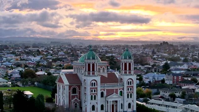Amazing drone flyover Sacred Heart Basilica to sunset colorful sky in Timaru, New Zealand