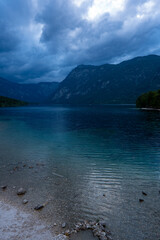 Amazing huge cloud above giant mountains. Raindrops on mountain lake. Beautiful rain drops. Wonderful droplets on lake water. Low clouds. Cloudy sky. Wonderful atmospheric ghostly highland landscape.