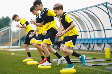Sports Balance Training. Teenage Football Players Standing On Balance Cushions During Football...