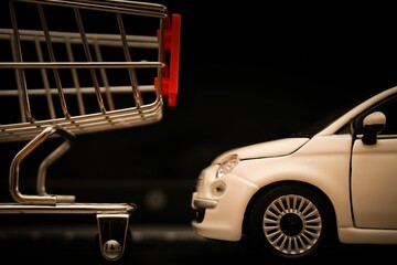 Fototapeta premium Miniature shopping cart and a car