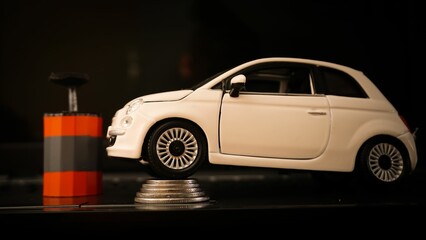 Fototapeta premium Car expenses concept with miniature toy car on stack of coins