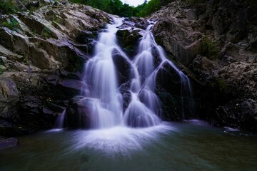 Scenic long exposure shot of a magical waterfall in a forest