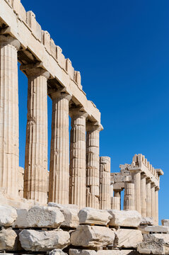 Ancient temple Parthenon in Acropolis Athens Greece on a bright blue sky background. The best travel destinations. Vertical photo.