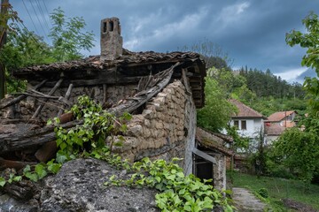 Fototapeta na wymiar Old abandoned broken house on a cloudy day in Ohrid, North Macedonia