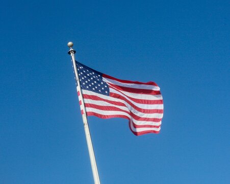 Closeup shot of the waving USA flag on a pole